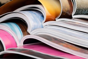Close-up of stack of colorful magazines. Press news and magazines concept